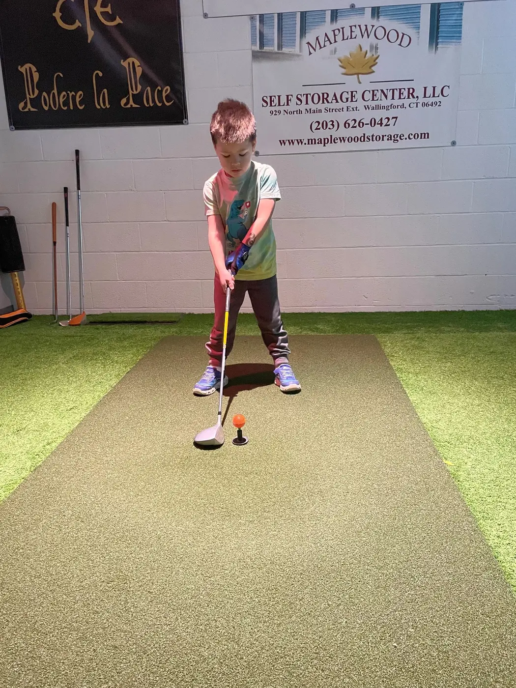 A four-year-old golfer in a ready stance over the ball