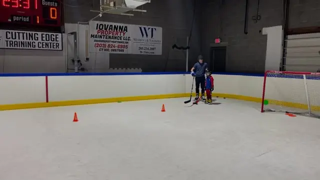 Young hockey players running a drill on the ice